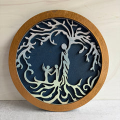 Decorative wall art with tree design on a blue background, framed in brown.