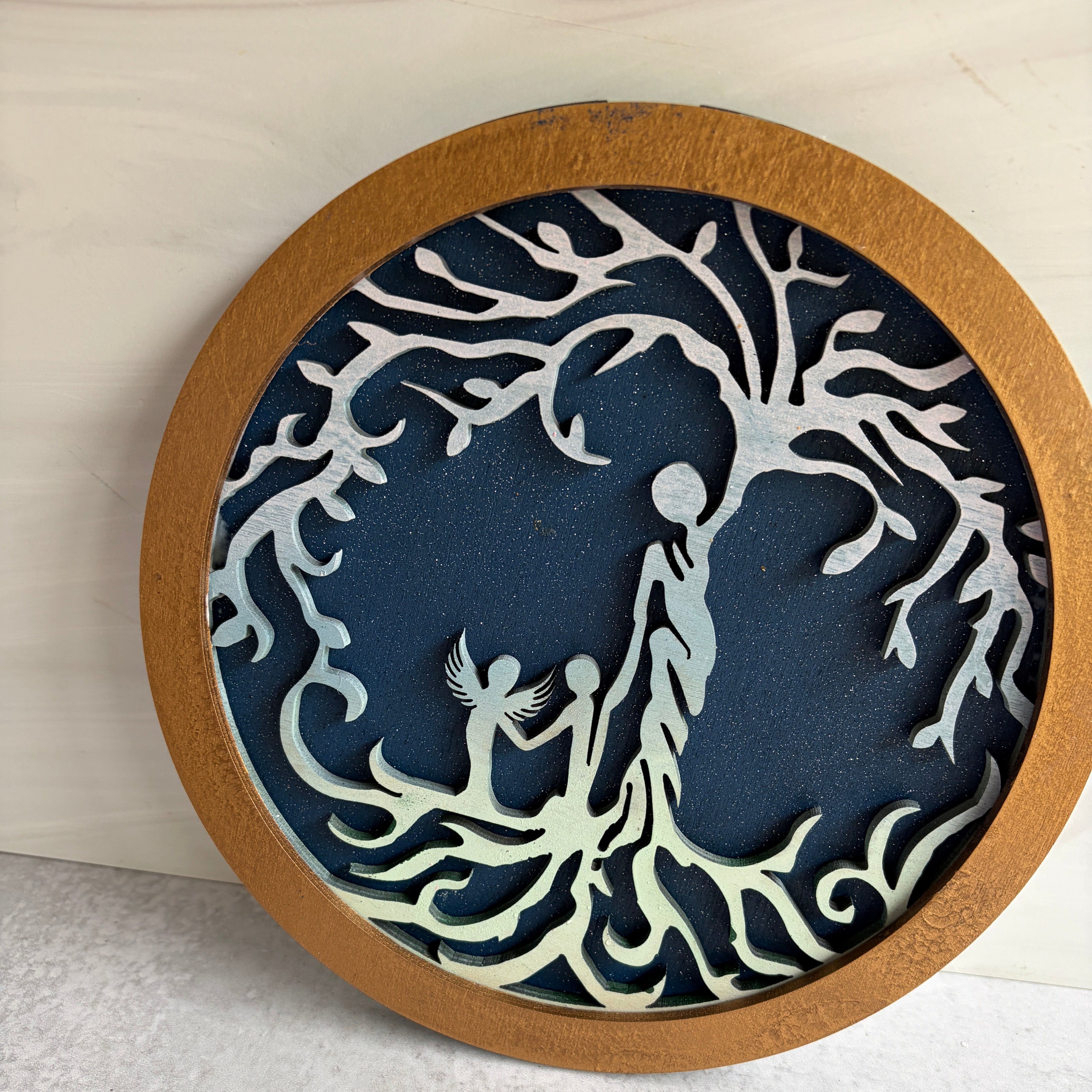 Decorative wall art with a seahorse design on a blue background, framed in wood.